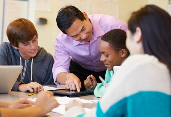 a group a students and a teacher working together