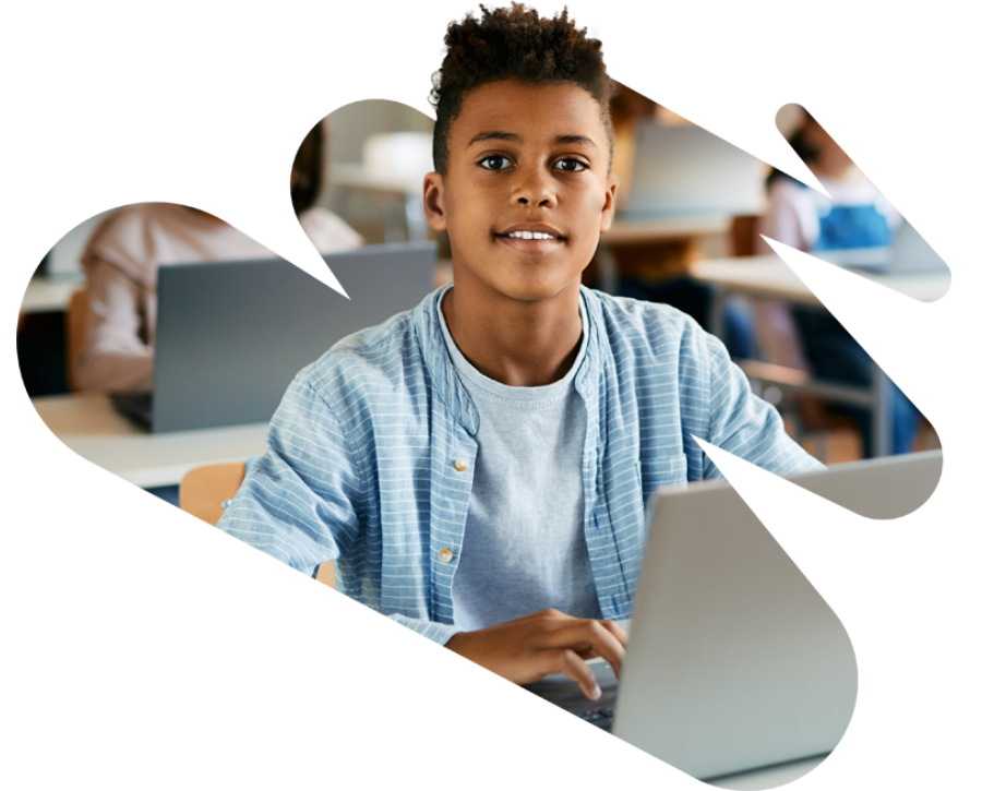 A student sitting in a classroom with a laptop