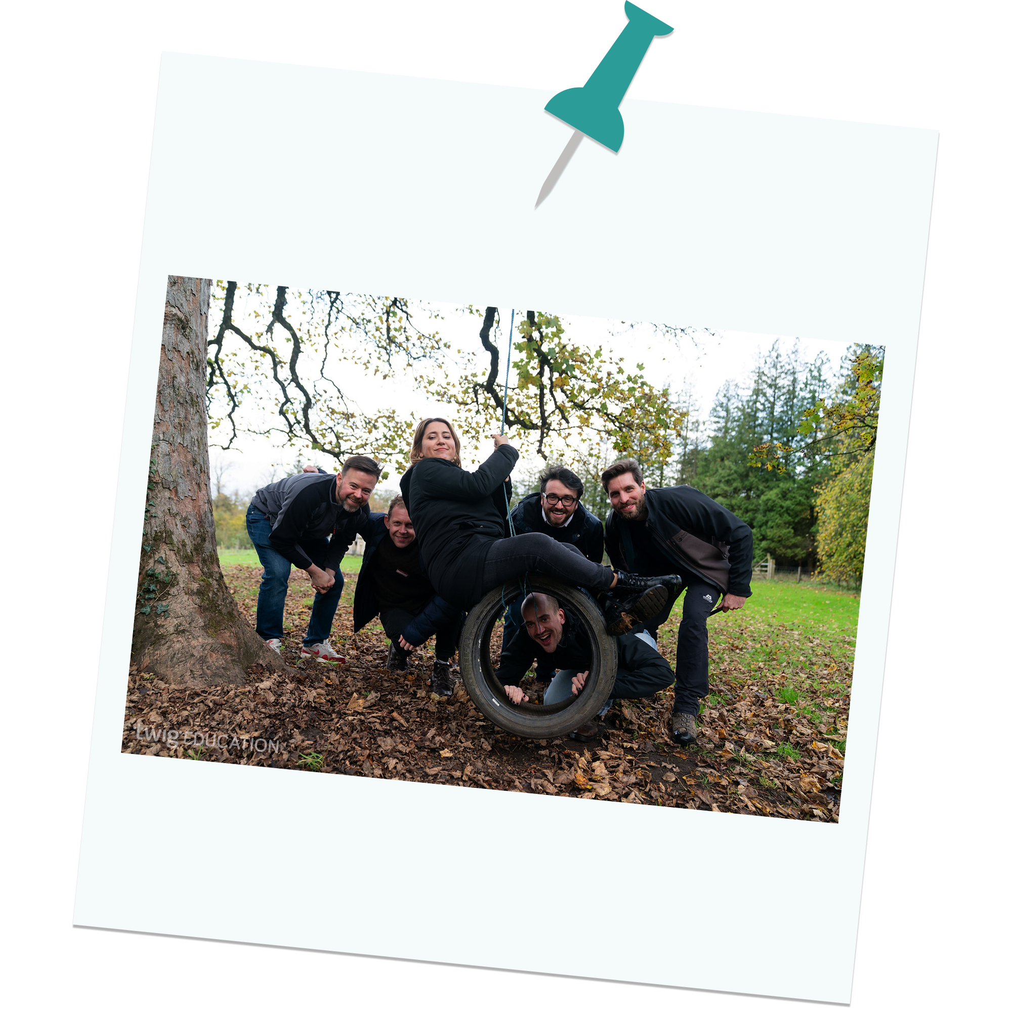 A group of Imagine Learning Studios employees on a tyre swing