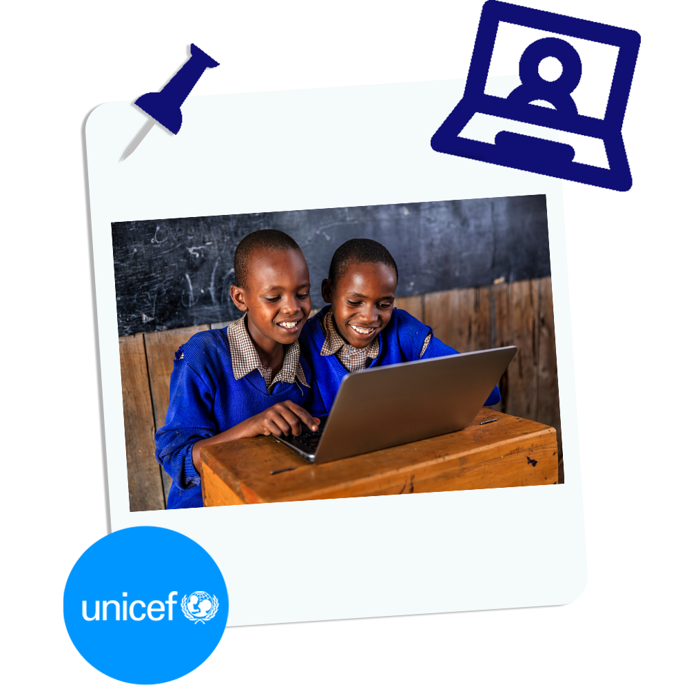 Unicef Graphic | Two children working at a laptop